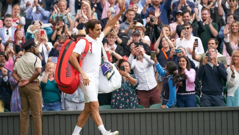 Jul 7, 2021; London, United Kingdom; Roger Federer (SUI) waving farewell to the Centre Court fans after losing to Hubert Hurkacz (POL) in the quarter finals at All England Lawn Tennis and Croquet Club. Mandatory Credit: Peter van den Berg-USA TODAY Sports