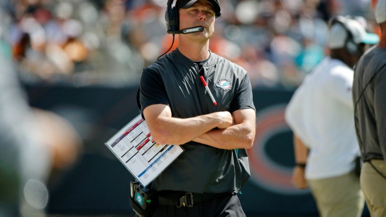 Aug 14, 2021; Chicago, Illinois, USA; Miami Dolphins defensive coordinator Josh Boyer watches the game against the Chicago Bears from the sideline during the second half at Soldier Field. Mandatory Credit: Jon Durr-USA TODAY Sports