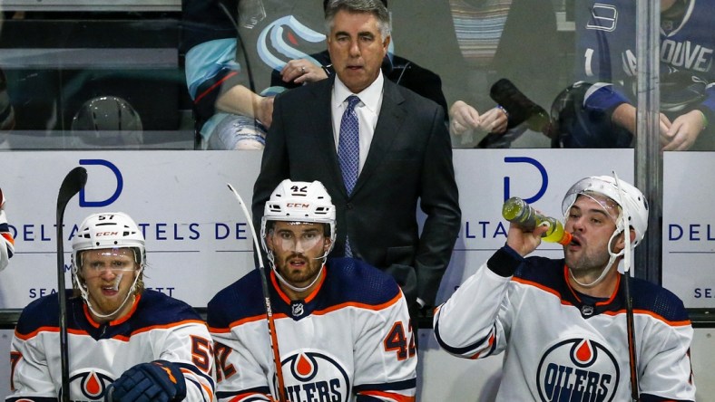 Oct 1, 2021; Everett, Washington, USA; Edmonton Oilers head coach Dave Tippett watches play against the Seattle Kraken during the third period at Angel of the Winds Arena. Mandatory Credit: Joe Nicholson-USA TODAY Sports