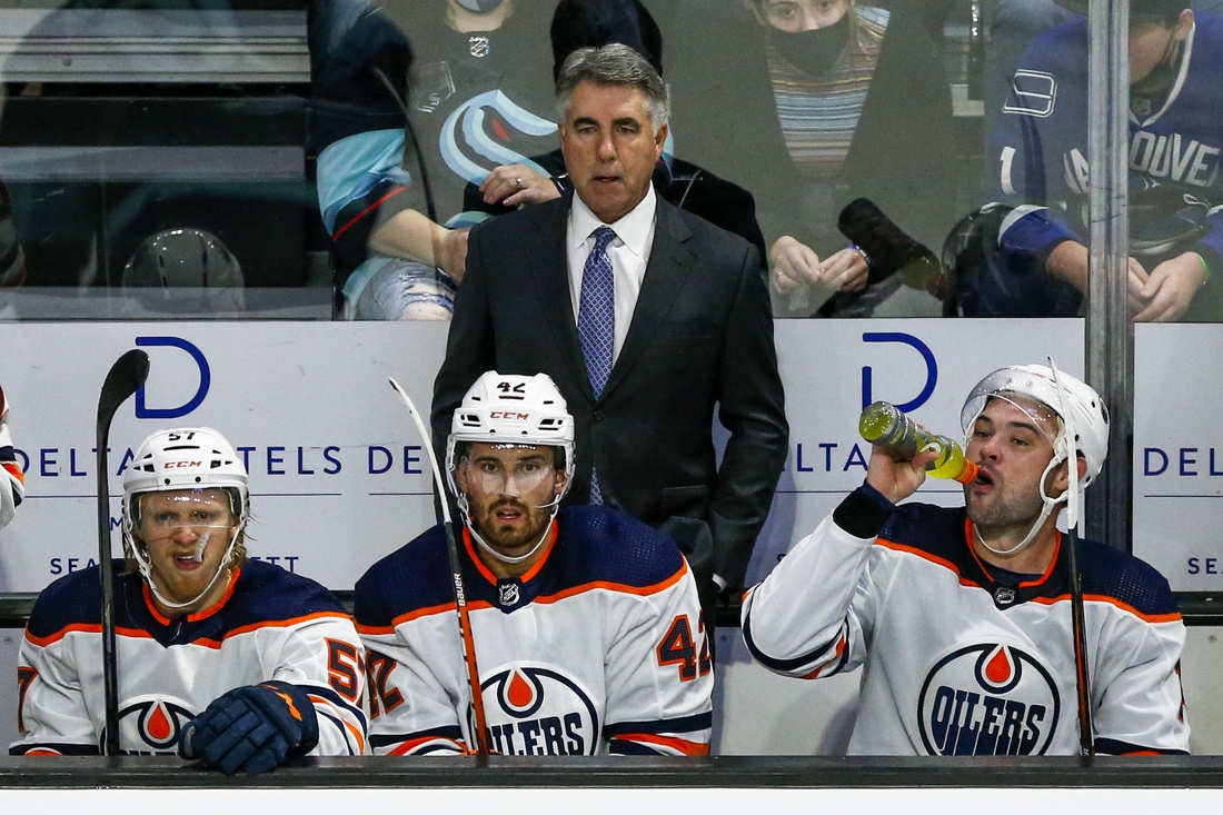 Oct 1, 2021; Everett, Washington, USA; Edmonton Oilers head coach Dave Tippett watches play against the Seattle Kraken during the third period at Angel of the Winds Arena. Mandatory Credit: Joe Nicholson-USA TODAY Sports