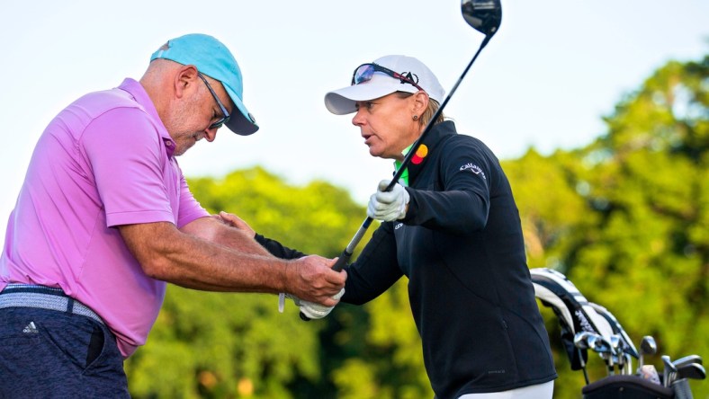 Annika Sorenstam helps Steven Collis with his game during a charity golf clinic presented by Jack Nicklaus, Sorenstam and Ernie Els at PGA National in Palm Beach Gardens Monday, October 4, 2021.