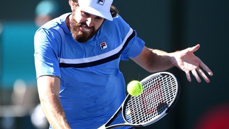 Oct 11, 2021; Indian Wells, CA, USA; Reilly Opelka (USA) hits a shot against Grigor Dimitrov (BUL) during his third round match in the BNP Paribas Open at the Indian Wells Tennis Garden. Mandatory Credit: Jayne Kamin-Oncea-USA TODAY Sports