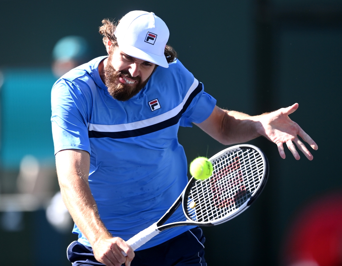 Oct 11, 2021; Indian Wells, CA, USA; Reilly Opelka (USA) hits a shot against Grigor Dimitrov (BUL) during his third round match in the BNP Paribas Open at the Indian Wells Tennis Garden. Mandatory Credit: Jayne Kamin-Oncea-USA TODAY Sports