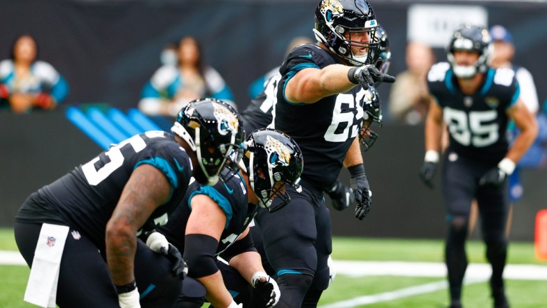 Oct 17, 2021; London, England, United Kingdom;  Jacksonville Jaguars center Tyler Shatley (69) directs the line against the Miami Dolphins at Tottenham Hotspur Stadium. Mandatory Credit: Nathan Ray Seebeck-USA TODAY Sports