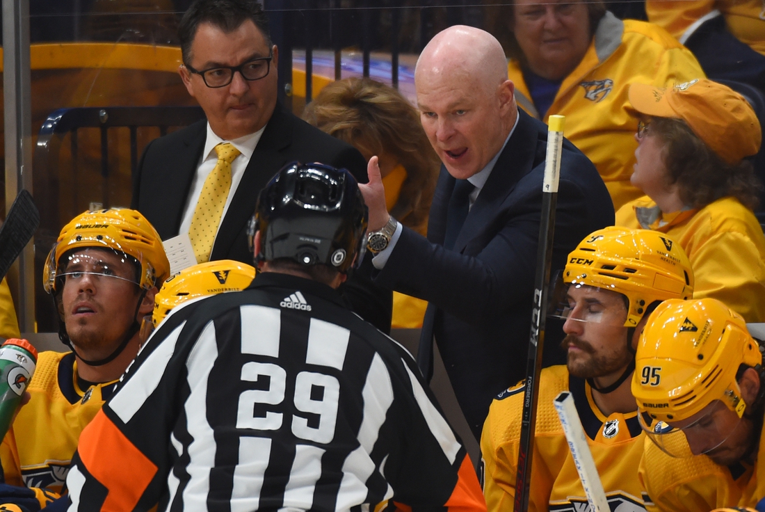 Oct 14, 2021; Nashville, Tennessee, USA; Nashville Predators head coach John Hynes talks with referee Ian Walsh (29) against the Seattle Kraken at Bridgestone Arena. Mandatory Credit: Christopher Hanewinckel-USA TODAY Sports