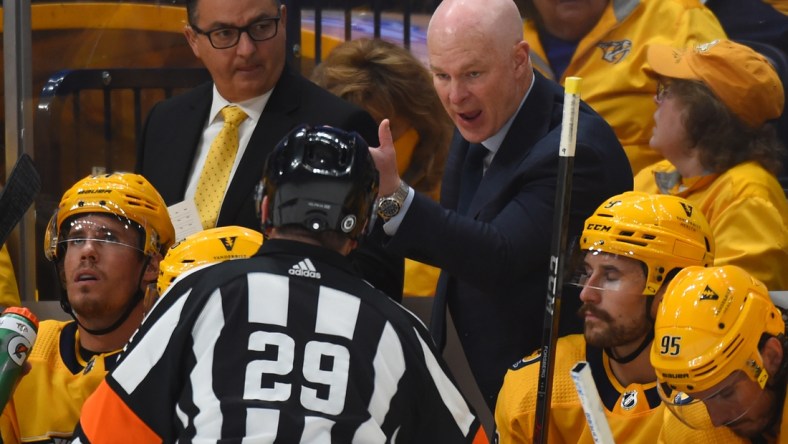 Oct 14, 2021; Nashville, Tennessee, USA; Nashville Predators head coach John Hynes talks with referee Ian Walsh (29) against the Seattle Kraken at Bridgestone Arena. Mandatory Credit: Christopher Hanewinckel-USA TODAY Sports