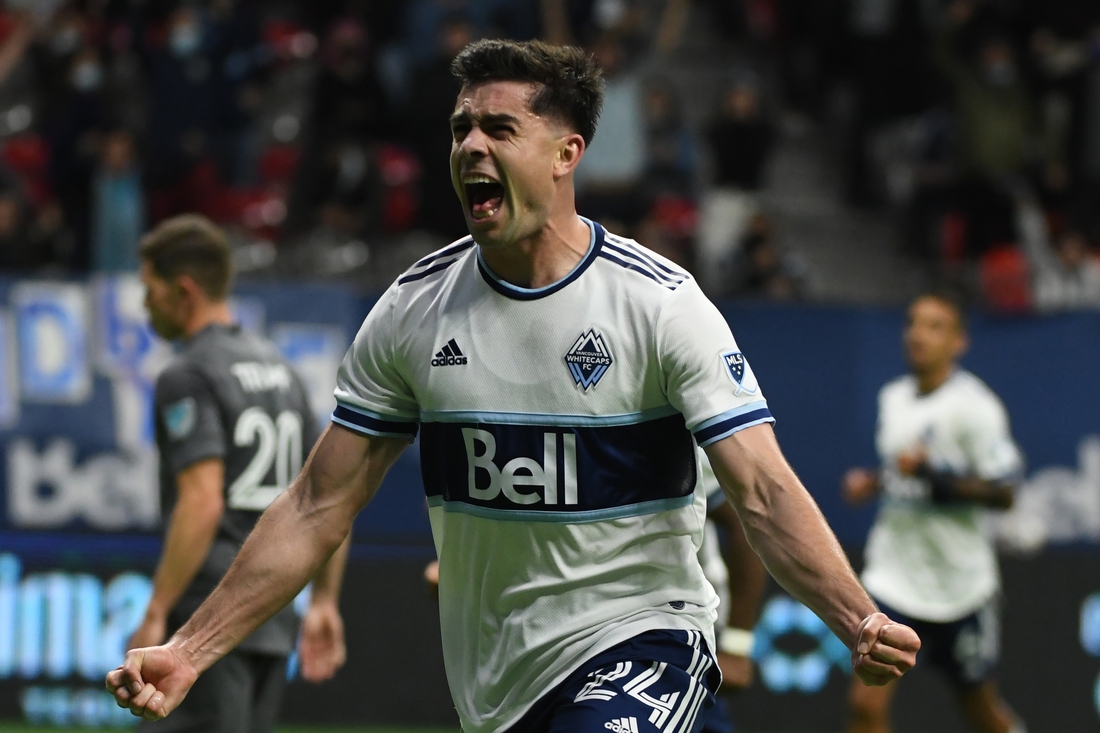 Oct 27, 2021; Vancouver, British Columbia, CAN;  Vancouver Whitecaps forward Brian White (24) scores against Minnesota United FC goalkeeper Tyler Miller (1) (not pictured) during the second half at BC Place. Mandatory Credit: Anne-Marie Sorvin-USA TODAY Sports