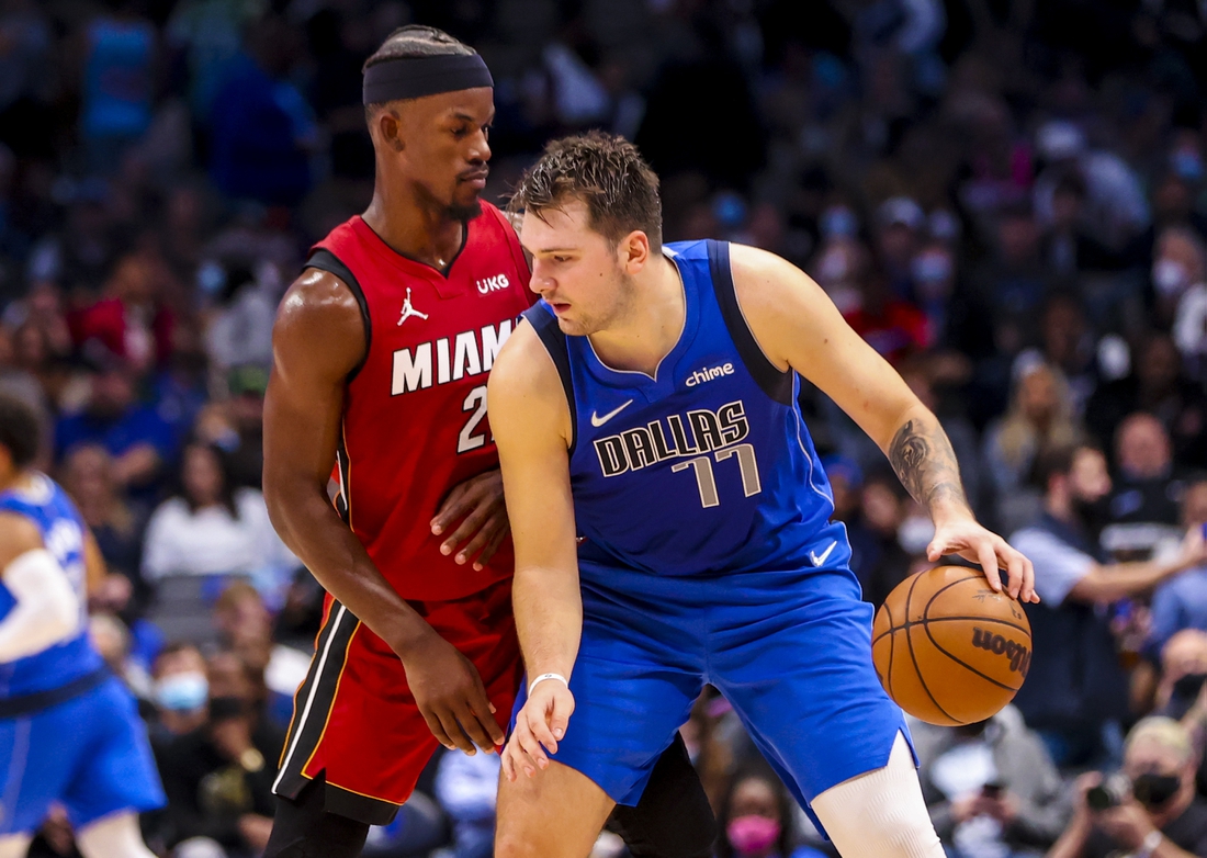 Nov 2, 2021; Dallas, Texas, USA;  Dallas Mavericks guard Luka Doncic (77) dribbles as Miami Heat forward Jimmy Butler (22) defends during the fourth quarter at American Airlines Center. Mandatory Credit: Kevin Jairaj-USA TODAY Sports