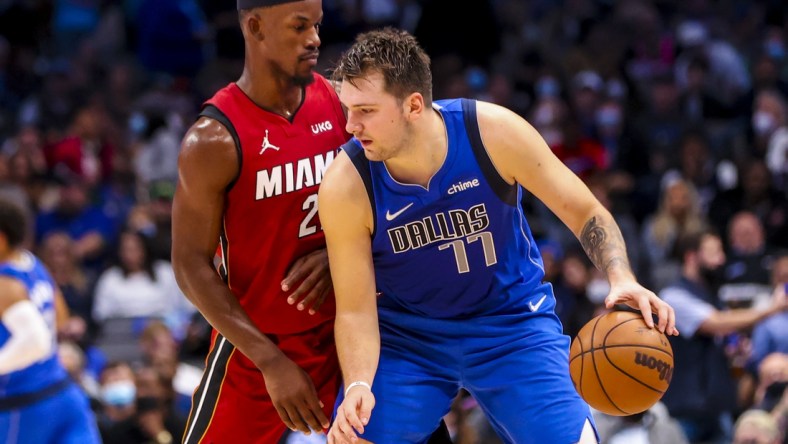 Nov 2, 2021; Dallas, Texas, USA;  Dallas Mavericks guard Luka Doncic (77) dribbles as Miami Heat forward Jimmy Butler (22) defends during the fourth quarter at American Airlines Center. Mandatory Credit: Kevin Jairaj-USA TODAY Sports