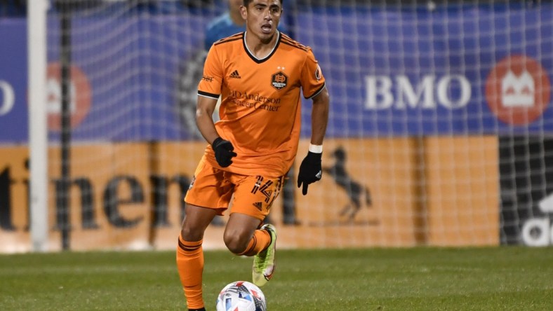 Nov 3, 2021; Montreal, Quebec, CAN; Houston Dynamo FC midfielder Joe Corona (14) plays the ball during the second half against the CF Montreal at Stade Saputo. Mandatory Credit: Eric Bolte-USA TODAY Sports