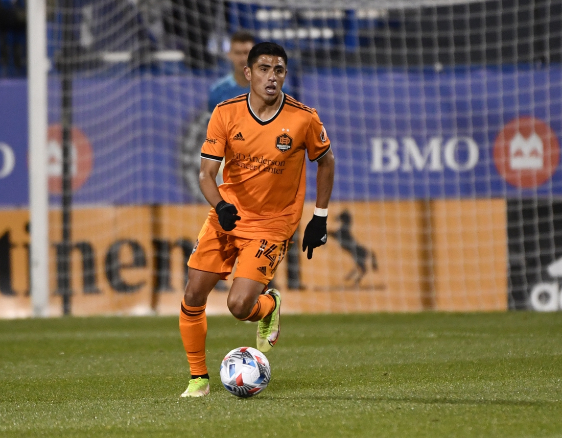 Nov 3, 2021; Montreal, Quebec, CAN; Houston Dynamo FC midfielder Joe Corona (14) plays the ball during the second half against the CF Montreal at Stade Saputo. Mandatory Credit: Eric Bolte-USA TODAY Sports