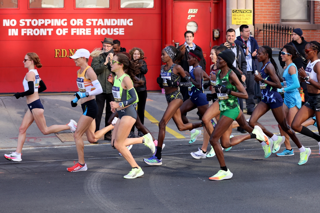 Nov 7, 2021; New York, New York, USA;  Elite runners go by a fire house in Brooklyn during the New York City Marathon.  Mandatory Credit: Kevin R. Wexler-USA TODAY Sports