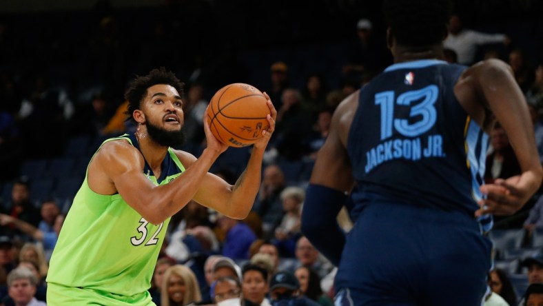 Nov 8, 2021; Memphis, Tennessee, USA; Minnesota Timberwolves center/forward Karl-Anthony Towns (32) shoots for three during the first half against the Memphis Grizzles at FedExForum. Mandatory Credit: Petre Thomas-USA TODAY Sports