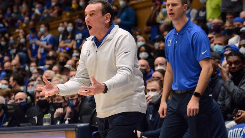 Nov 22, 2021; Durham, North Carolina, USA;  Duke Blue Devils head coach Mike Krzyzewski (left) and associate head coach Jon Scheyer react during the first half against Duke Blue Devils at Cameron Indoor Stadium. Mandatory Credit: Rob Kinnan-USA TODAY Sports