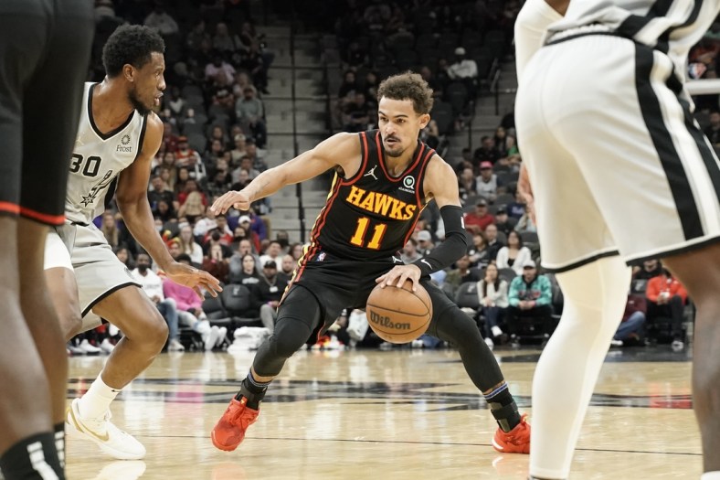 Nov 24, 2021; San Antonio, Texas, USA;  Atlanta Hawks guard Trae Young (11) drives to the basket while defended by San Antonio Spurs forward Thaddeus Young (30) during the second half at AT&T Center. Mandatory Credit: Scott Wachter-USA TODAY Sports