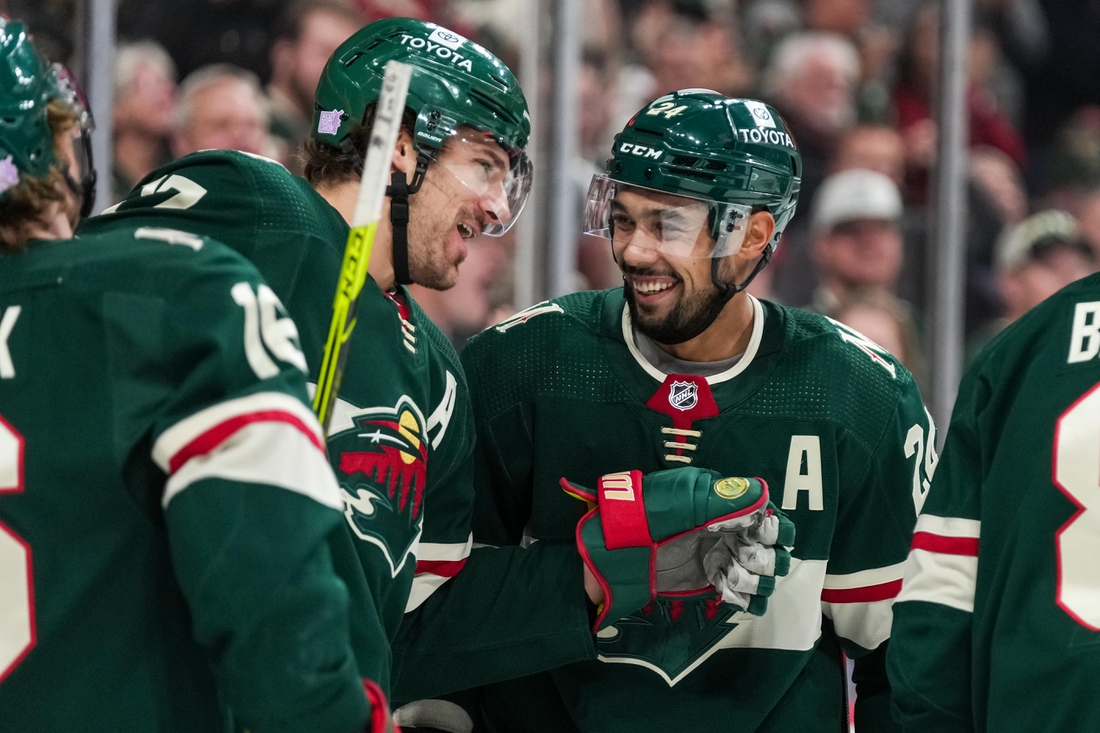 Nov 26, 2021; Saint Paul, Minnesota, USA; Minnesota Wild defenseman Mathew Dumba (24) celebrates his goal with forward Marcus Foligno (17) during the third period against the Winnipeg Jets at Xcel Energy Center. Mandatory Credit: Brace Hemmelgarn-USA TODAY Sports