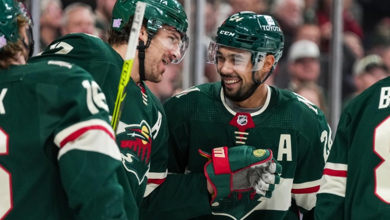 Nov 26, 2021; Saint Paul, Minnesota, USA; Minnesota Wild defenseman Mathew Dumba (24) celebrates his goal with forward Marcus Foligno (17) during the third period against the Winnipeg Jets at Xcel Energy Center. Mandatory Credit: Brace Hemmelgarn-USA TODAY Sports