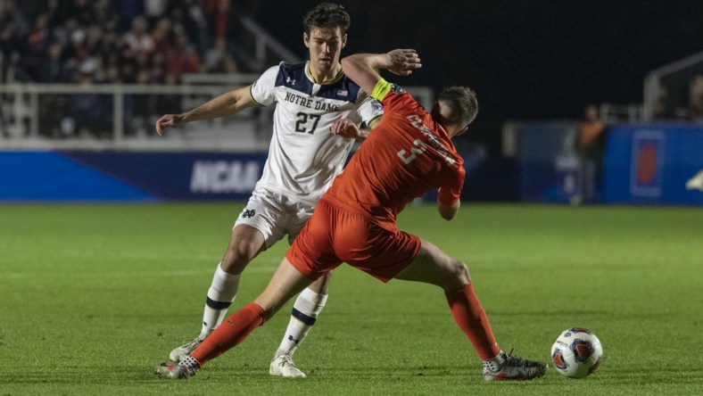 Dec 10, 2021; Cary, NC, USA; Clemson defender Oskar   gren (3) tries to deflect the dribble from Notre Dame forward Jack Lynn (27) during the second half of the NCAA College Cup semifinal game at WakeMed Soccer Park. Mandatory Credit: William Howard-USA TODAY Sports