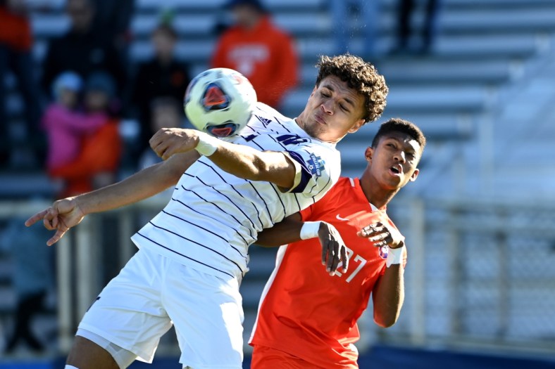 Dec 12, 2021; Cary, NC, USA;  Washington defender Kendall Burks (2) and Clemson forward Isaiah Reid (27) fight for the ball in the first half at WakeMed Soccer Park. Mandatory Credit: Bob Donnan-USA TODAY Sports