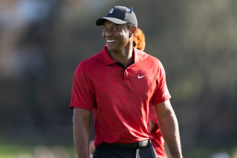 Dec 19, 2021; Orlando, Florida, USA; Tiger Woods smiling as he walks off the 17th green during the final round of the PNC Championship golf tournament at Grande Lakes Orlando Course. Mandatory Credit: Jeremy Reper-USA TODAY Sports