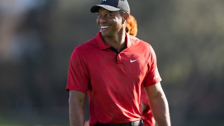 Dec 19, 2021; Orlando, Florida, USA; Tiger Woods smiling as he walks off the 17th green during the final round of the PNC Championship golf tournament at Grande Lakes Orlando Course. Mandatory Credit: Jeremy Reper-USA TODAY Sports