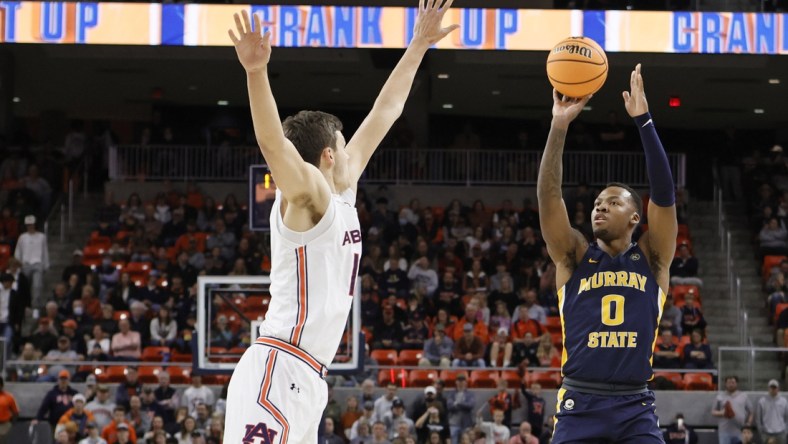 Dec 22, 2021; Auburn, Alabama, USA;  Murray State Racers forward KJ Williams (0) shoots over Auburn Tigers forward Jabari Smith (10) during the first half at Auburn Arena. Mandatory Credit: John Reed-USA TODAY Sports