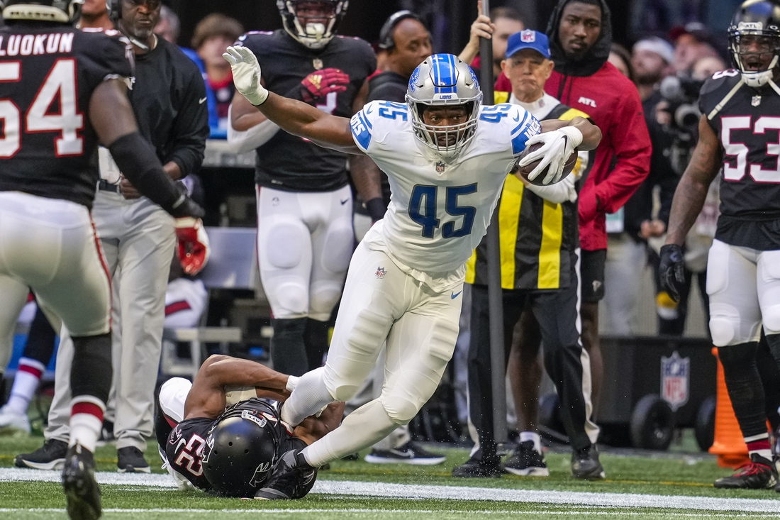 Dec 26, 2021; Atlanta, Georgia, USA; Detroit Lions fullback Jason Cabinda (45) tries to break out of a tackle by Atlanta Falcons cornerback Fabian Moreau (22) during the first quarter at Mercedes-Benz Stadium. Mandatory Credit: Dale Zanine-USA TODAY Sports