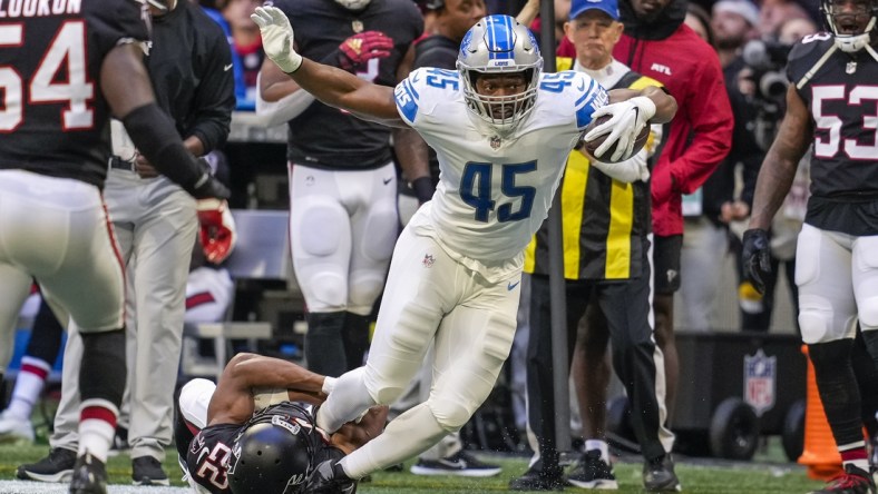 Dec 26, 2021; Atlanta, Georgia, USA; Detroit Lions fullback Jason Cabinda (45) tries to break out of a tackle by Atlanta Falcons cornerback Fabian Moreau (22) during the first quarter at Mercedes-Benz Stadium. Mandatory Credit: Dale Zanine-USA TODAY Sports