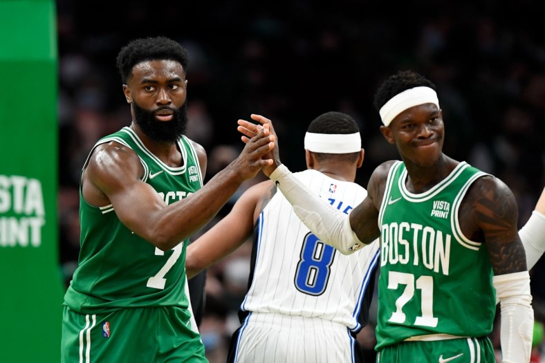 Jan 2, 2022; Boston, Massachusetts, USA; Boston Celtics guard Jaylen Brown (7) high-fives guard Dennis Schroder (71) during the second half of a game against the Orlando Magic at the TD Garden. Mandatory Credit: Brian Fluharty-USA TODAY Sports