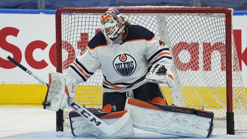 Jan 5, 2022; Toronto, Ontario, CAN; Edmonton Oilers goaltender Mike Smith (41) makes a save during warm ups before a game against the Toronto Maple Leafs at Scotiabank Arena. Mandatory Credit: John E. Sokolowski-USA TODAY Sports