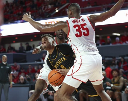 Jan 8, 2022; Houston, Texas, USA; Wichita State Shockers guard Dexter Dennis (0) attempts to control the ball as Houston Cougars forward Fabian White Jr. (35) defends during the second half at Fertitta Center. Mandatory Credit: Troy Taormina-USA TODAY Sports