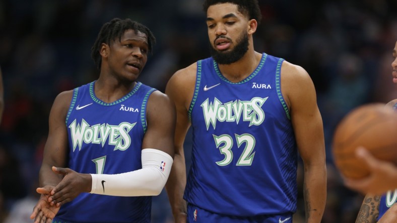 Jan 11, 2022; New Orleans, Louisiana, USA; Minnesota Timberwolves forward Anthony Edwards (1) talks to center Karl-Anthony Towns (32) in the first quarter against the New Orleans Pelicans at the Smoothie King Center. Mandatory Credit: Chuck Cook-USA TODAY Sports