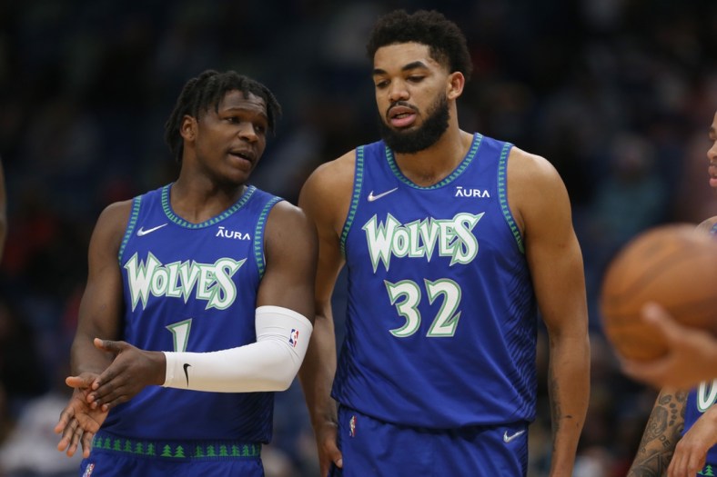 Jan 11, 2022; New Orleans, Louisiana, USA; Minnesota Timberwolves forward Anthony Edwards (1) talks to center Karl-Anthony Towns (32) in the first quarter against the New Orleans Pelicans at the Smoothie King Center. Mandatory Credit: Chuck Cook-USA TODAY Sports