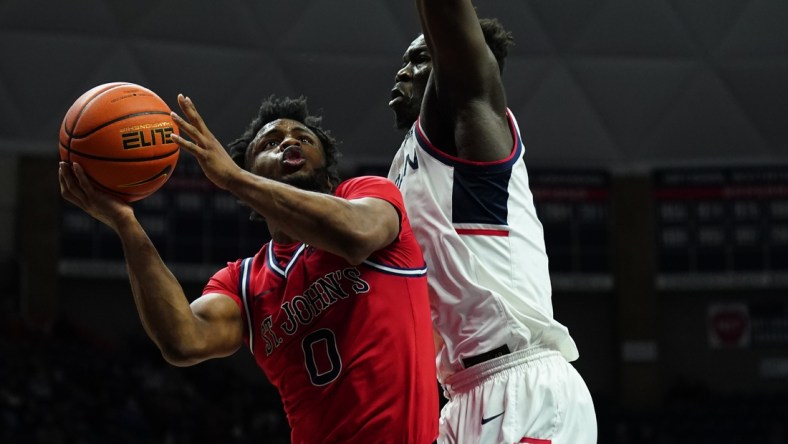 Jan 12, 2022; Storrs, Connecticut, USA; Connecticut Huskies forward Adama Sanogo (21) defends against St. John's Red Storm guard Posh Alexander (0) in the second half at Harry A. Gampel Pavilion. Mandatory Credit: David Butler II-USA TODAY Sports