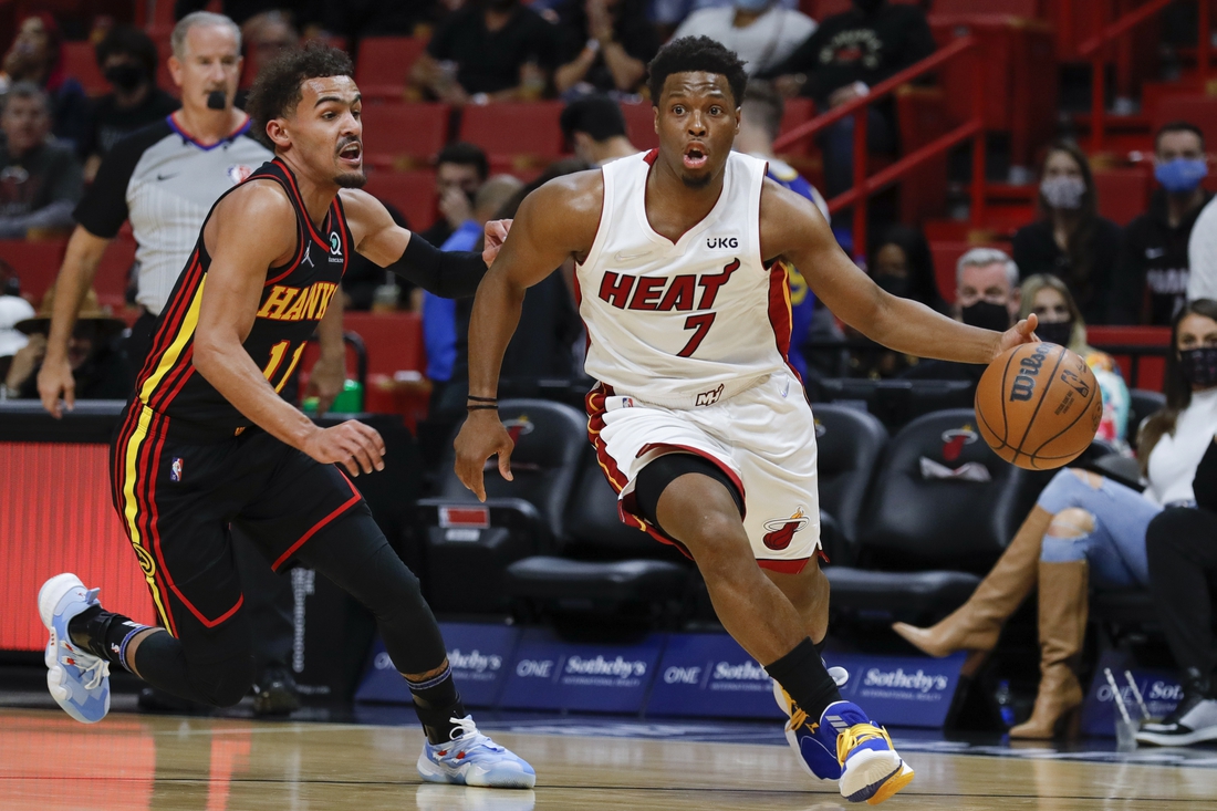 Jan 14, 2022; Miami, Florida, USA; Miami Heat guard Kyle Lowry (7) dribbles the ball around Atlanta Hawks guard Trae Young (11) during the first quarter of the game at FTX Arena. Mandatory Credit: Sam Navarro-USA TODAY Sports