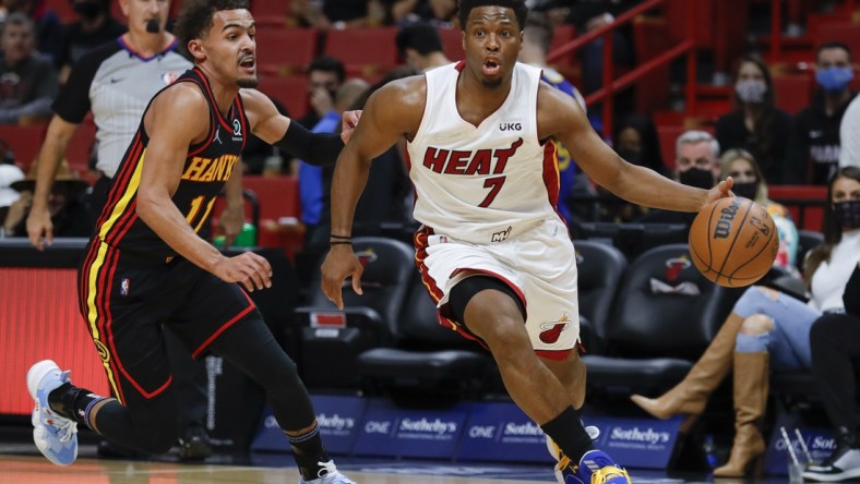 Jan 14, 2022; Miami, Florida, USA; Miami Heat guard Kyle Lowry (7) dribbles the ball around Atlanta Hawks guard Trae Young (11) during the first quarter of the game at FTX Arena. Mandatory Credit: Sam Navarro-USA TODAY Sports