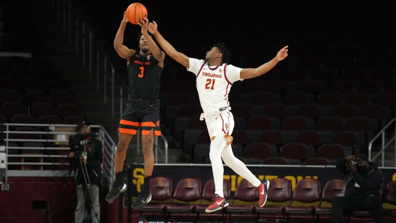 Jan 13, 2022; Los Angeles, California, USA; Oregon State guard Beavers Dexter Akanno (3) catches an inbounds pass as Southern California Trojans guard Reese Dixon-Waters (21) defends in the second half at Galen Center. USC defeated OSU 81-71. Mandatory Credit: Kirby Lee-USA TODAY Sports