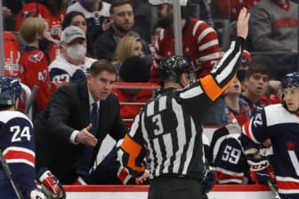 Jan 16, 2022; Washington, District of Columbia, USA; Washington Capitals head coach Peter Laviolette (L) argues a penalty call by referee Mike Leggo (3) during the game against the Vancouver Canucks during the third period at Capital One Arena. Mandatory Credit: Geoff Burke-USA TODAY Sports