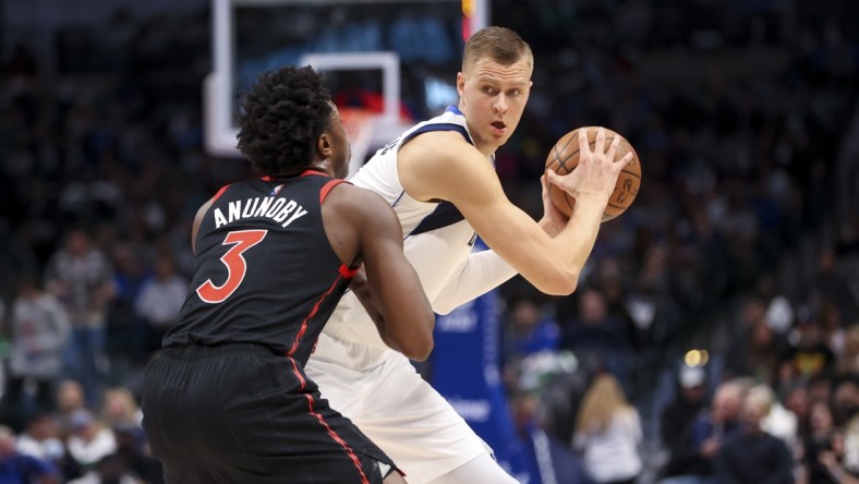 Jan 19, 2022; Dallas, Texas, USA;  Dallas Mavericks center Kristaps Porzingis (6) controls the ball as Toronto Raptors forward OG Anunoby (3) defends during the first quarter at American Airlines Center. Mandatory Credit: Kevin Jairaj-USA TODAY Sports