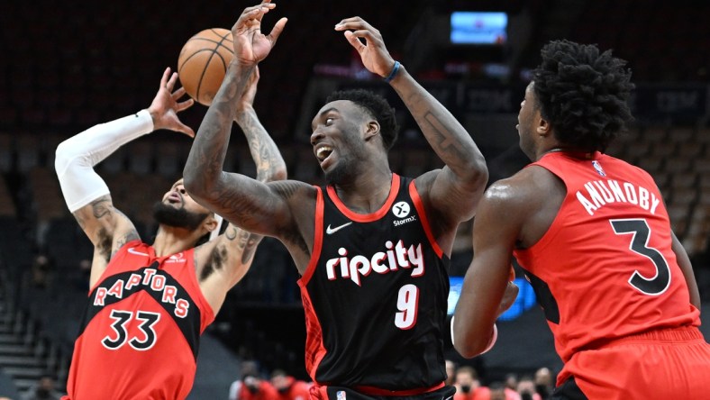 Jan 23, 2022; Toronto, Ontario, CAN;  Portland Trail Blazers forward Nassir Little (9) battles for a rebound with Toronto Raptors forward OG Anunoby (3) and guard Gary Trent Jr. (33) in the first half at Scotiabank Arena. Mandatory Credit: Dan Hamilton-USA TODAY Sports