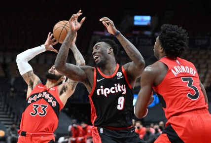 Jan 23, 2022; Toronto, Ontario, CAN;  Portland Trail Blazers forward Nassir Little (9) battles for a rebound with Toronto Raptors forward OG Anunoby (3) and guard Gary Trent Jr. (33) in the first half at Scotiabank Arena. Mandatory Credit: Dan Hamilton-USA TODAY Sports
