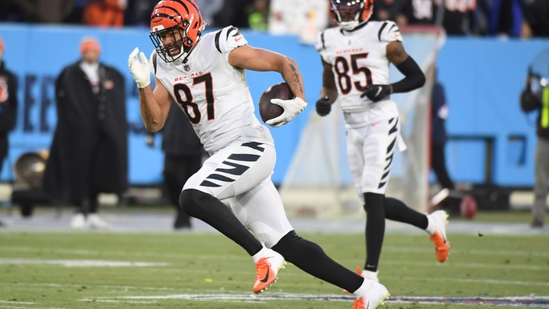 Jan 22, 2022; Nashville, Tennessee, USA; Cincinnati Bengals tight end C.J. Uzomah (87) runs after a reception against the Tennessee Titans during a AFC Divisional playoff football game at Nissan Stadium. Mandatory Credit: Christopher Hanewinckel-USA TODAY Sports