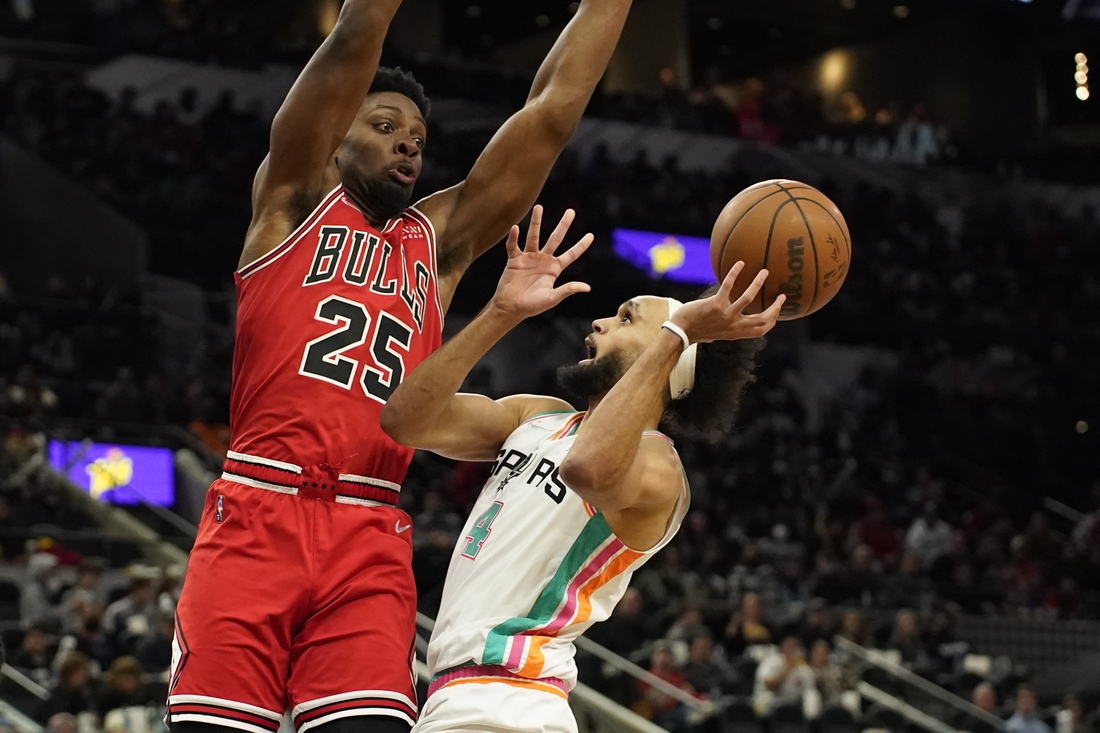 Jan 28, 2022; San Antonio, Texas, USA; San Antonio Spurs guard Derrick White (4) shoots over Chicago Bulls forward Tyler Cook (25) during the second half at ATT Center. Mandatory Credit: Scott Wachter-USA TODAY Sports