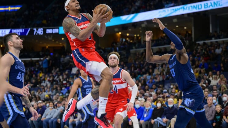 Jan 29, 2022; Memphis, Tennessee, USA; Washington Wizards guard Bradley Beal (3) drives to the basket past m48 and forward Jaren Jackson Jr. (13) during the second quarter at the FedExForum. Mandatory Credit: Jerome Miron-USA TODAY Sports