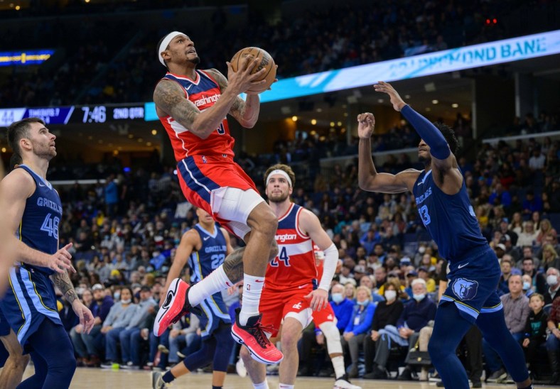 Jan 29, 2022; Memphis, Tennessee, USA; Washington Wizards guard Bradley Beal (3) drives to the basket past m48 and forward Jaren Jackson Jr. (13) during the second quarter at the FedExForum. Mandatory Credit: Jerome Miron-USA TODAY Sports