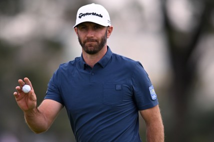 Jan 29, 2022; San Diego, California, USA; Dustin Johnson acknowledges the crowd after a putt on the first green during the final round of the Farmers Insurance Open golf tournament at Torrey Pines Municipal Golf Course - South Course. Mandatory Credit: Orlando Ramirez-USA TODAY Sports