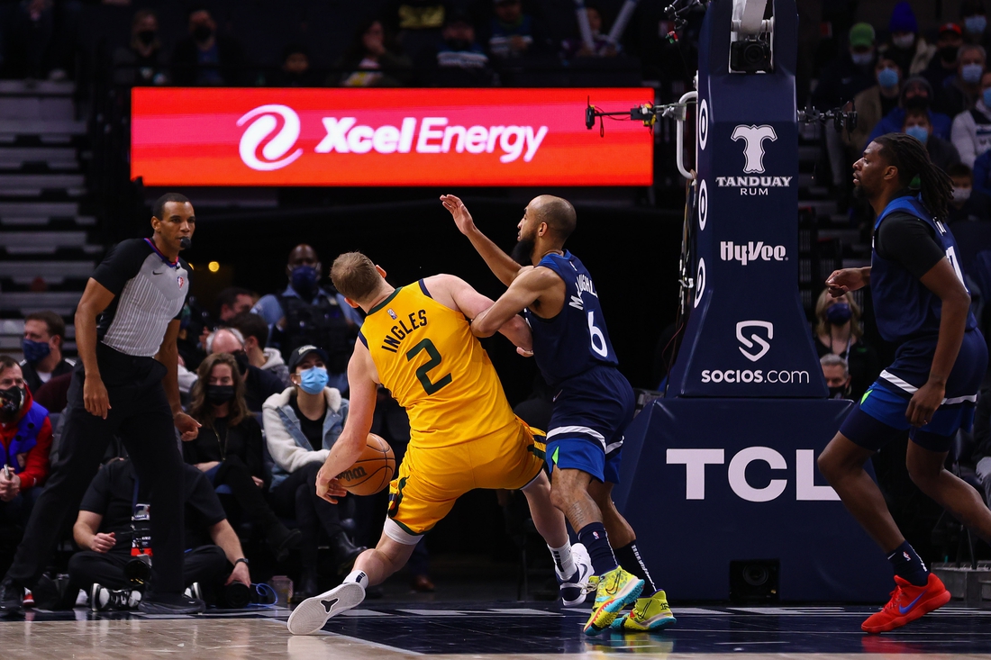 Jan 30, 2022; Minneapolis, Minnesota, USA; Utah Jazz guard Joe Ingles (2) injures his leg as Minnesota Timberwolves guard Jordan McLaughlin (6) defends during the second quarter at Target Center. Mandatory Credit: Harrison Barden-USA TODAY Sports