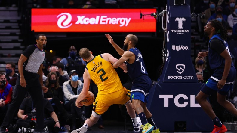 Jan 30, 2022; Minneapolis, Minnesota, USA; Utah Jazz guard Joe Ingles (2) injures his leg as Minnesota Timberwolves guard Jordan McLaughlin (6) defends during the second quarter at Target Center. Mandatory Credit: Harrison Barden-USA TODAY Sports