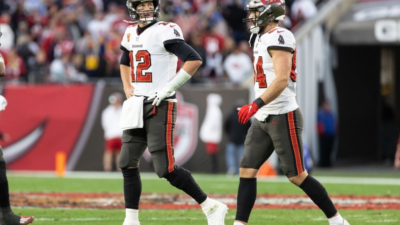 Jan 23, 2022; Tampa, Florida, USA; Tampa Bay Buccaneers quarterback Tom Brady (12) walks off the field looking at the scoreboard during the second half against the Los Angeles Rams during a NFC Divisional playoff football game at Raymond James Stadium. Mandatory Credit: Matt Pendleton-USA TODAY Sports