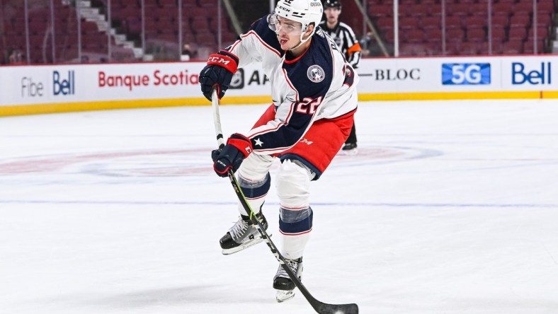 Jan 30, 2022; Montreal, Quebec, CAN; Columbus Blue Jackets defenseman Jake Bean (22) shoots the puck during the first period at Bell Centre. Mandatory Credit: David Kirouac-USA TODAY Sports